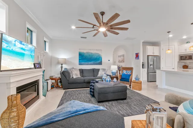 a living room with furniture a fireplace and a flat screen tv