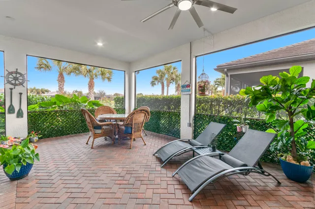 a view of a patio with plants and chairs