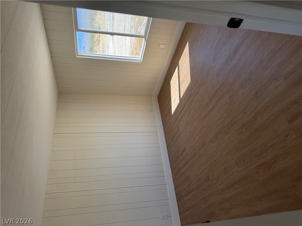 6401 Hafen Ranch Road Pahrump, NV 89061 - Photo 19 of 22 Smooth wood-look flooring and horizontal wall paneling define this versatile, window-lit interior space.
