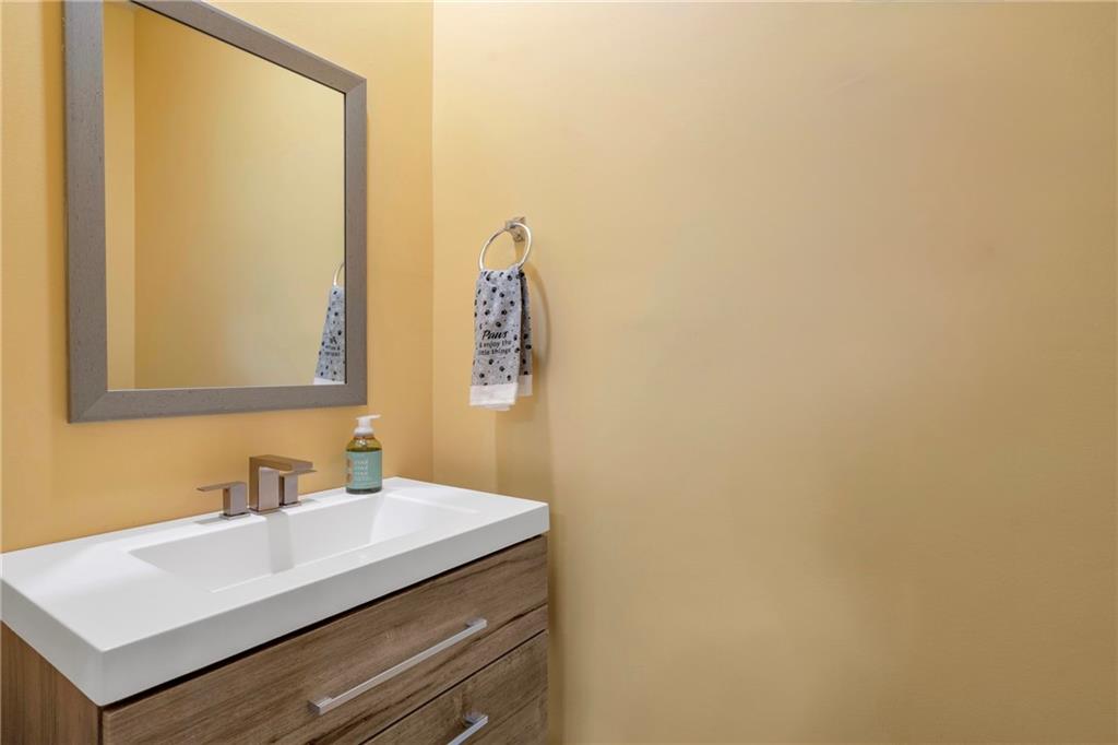 660 Groover Street Ball Ground, GA 30107 - Photo 20 of 53 a bathroom with a sink and a mirror