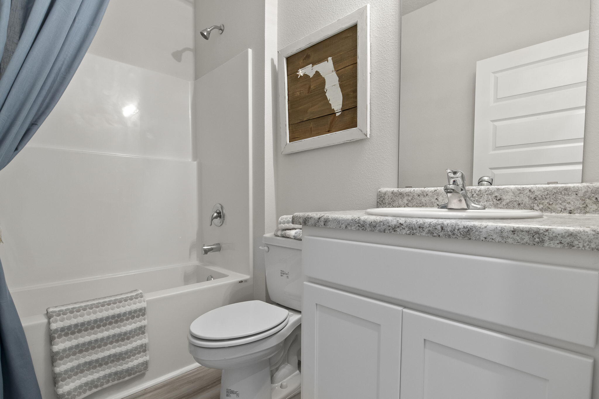 6533 Burleson Boulevard Crestview, FL 32539 - Photo 22 of 38 a bathroom with a granite countertop toilet sink and shower