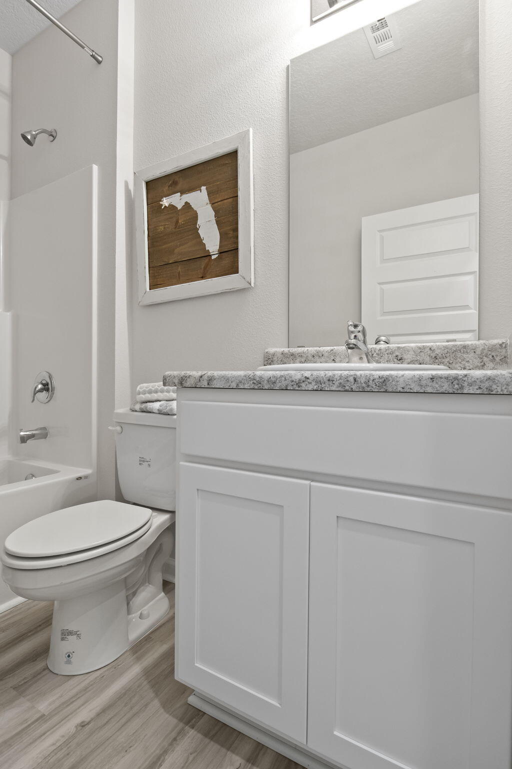 6533 Burleson Boulevard Crestview, FL 32539 - Photo 23 of 38 a bathroom with a toilet a sink and mirror