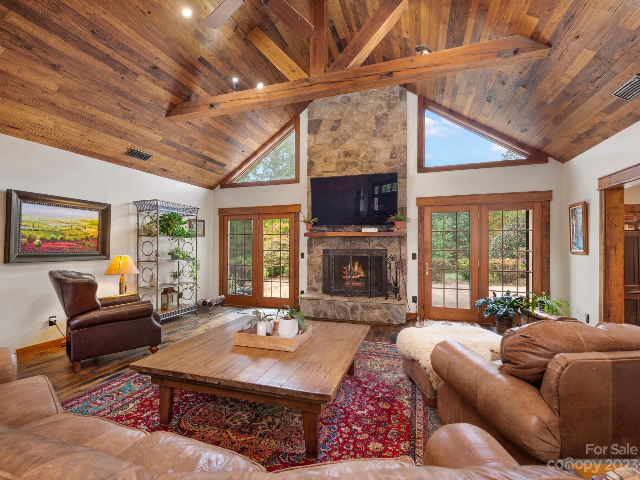 574 Golden Road Columbus, NC 28722 - Photo 17 of 48 a living room with furniture a fireplace and a flat screen tv