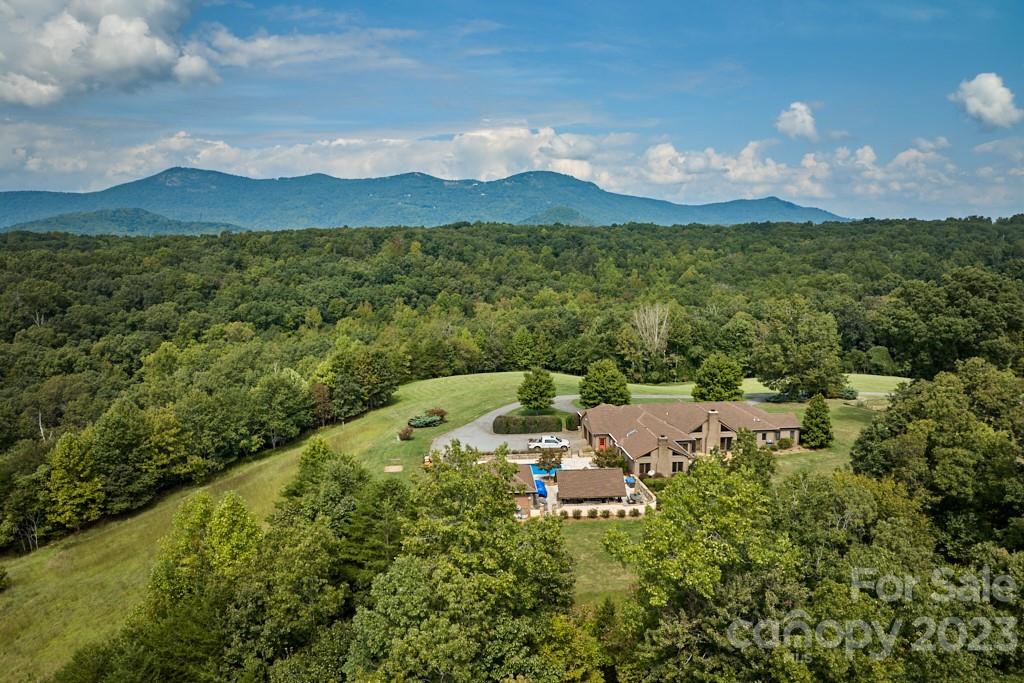 574 Golden Road Columbus, NC 28722 - Photo 2 of 48 a view of a lush green hillside and houses