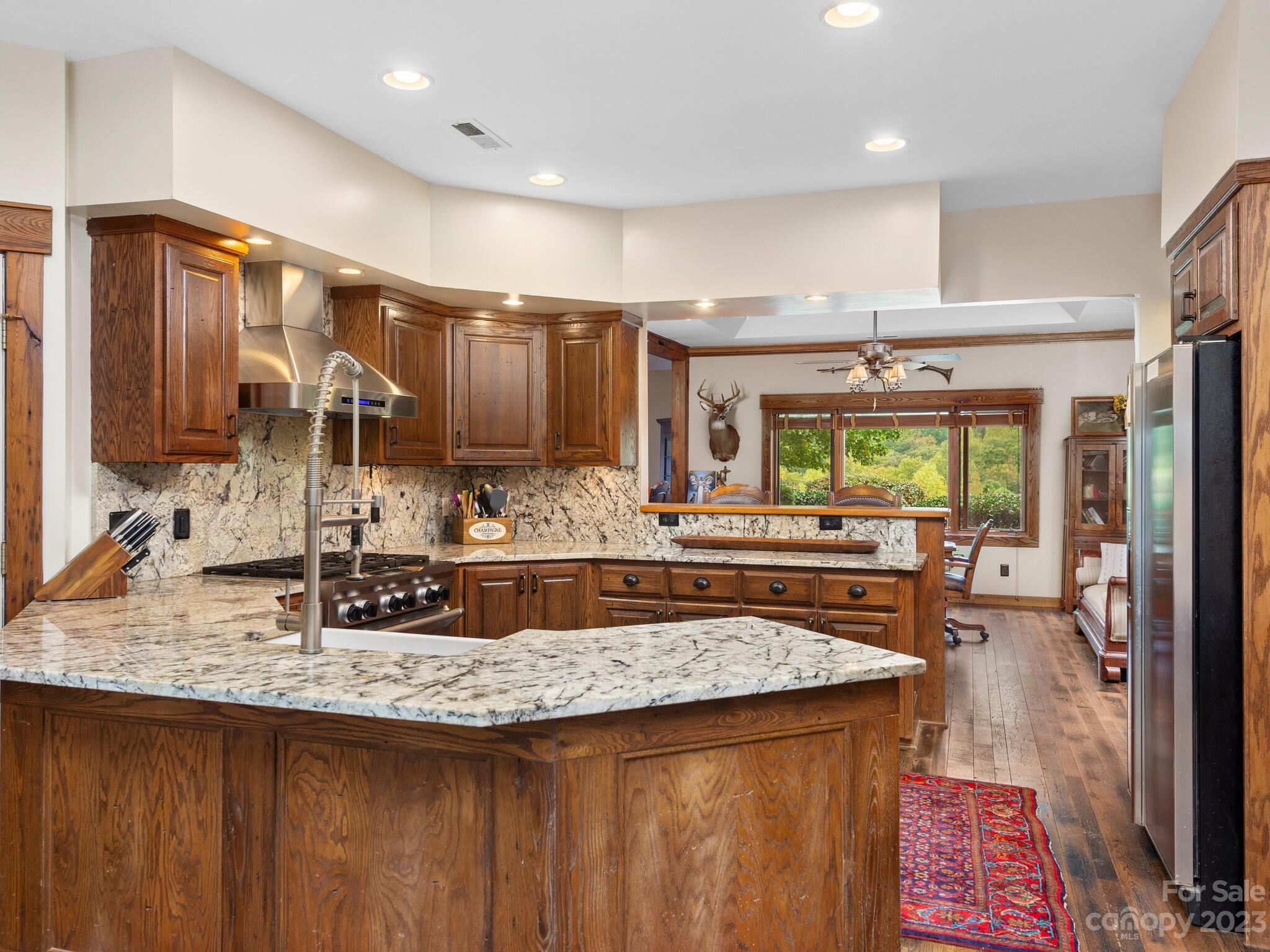 574 Golden Road Columbus, NC 28722 - Photo 21 of 48 a kitchen with kitchen island granite countertop a sink stove and cabinets