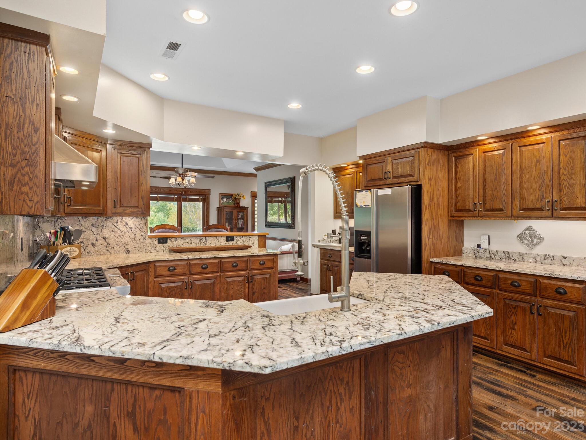 574 Golden Road Columbus, NC 28722 - Photo 22 of 48 a kitchen with kitchen island granite countertop a sink and refrigerator