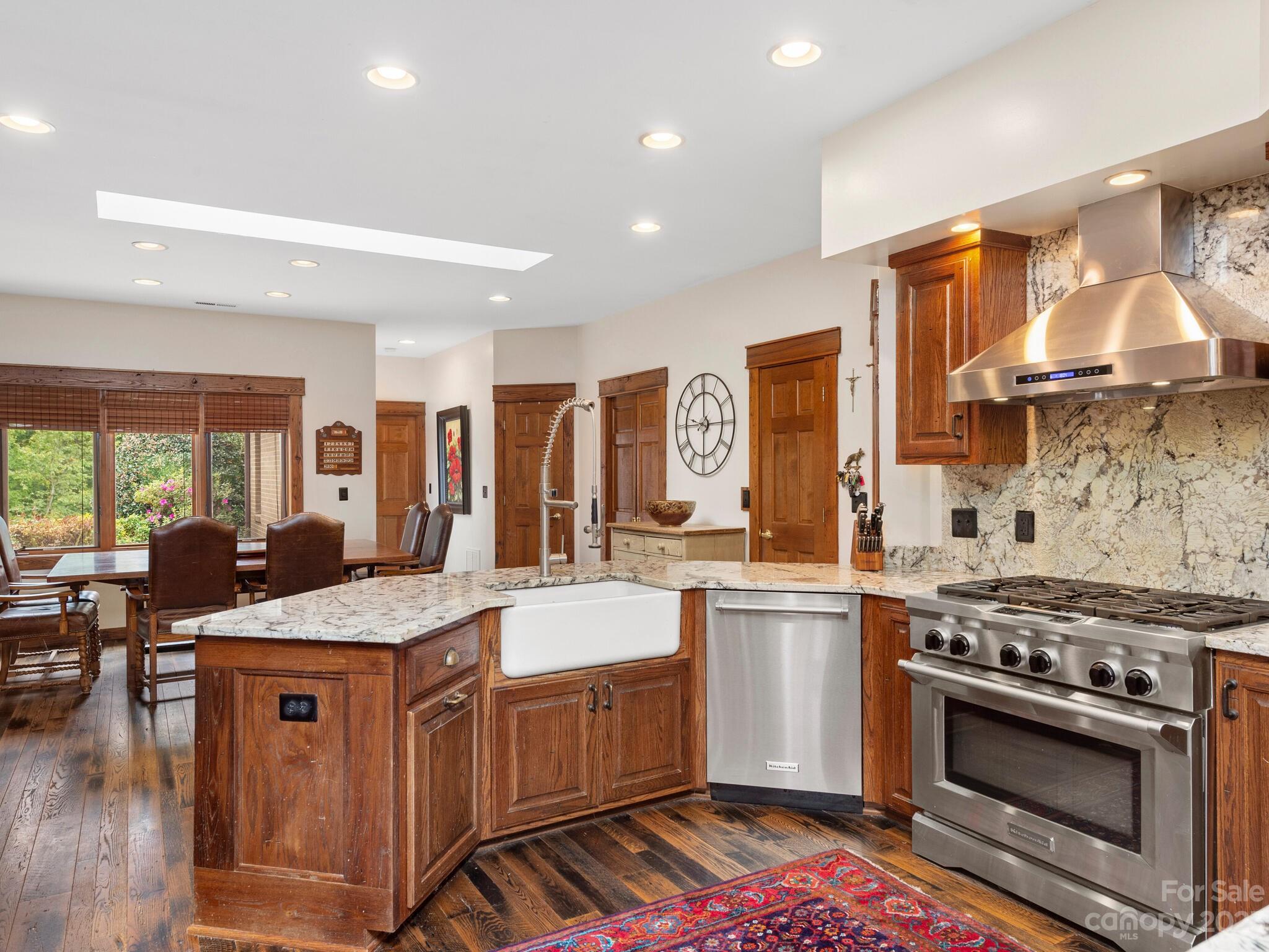 574 Golden Road Columbus, NC 28722 - Photo 23 of 48 a kitchen with stainless steel appliances granite countertop a stove a sink and a refrigerator