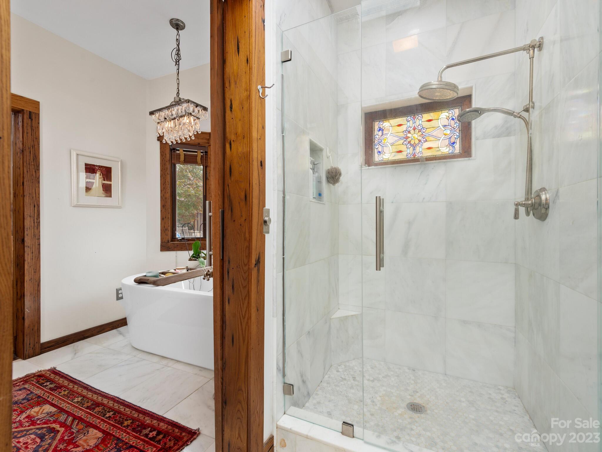 574 Golden Road Columbus, NC 28722 - Photo 34 of 48 a bathroom with a shower a mirror and a sink