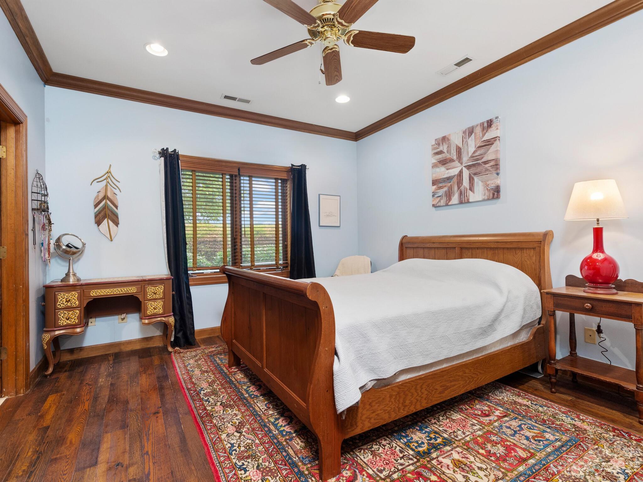 574 Golden Road Columbus, NC 28722 - Photo 35 of 48 a bedroom with a bed and a chandelier