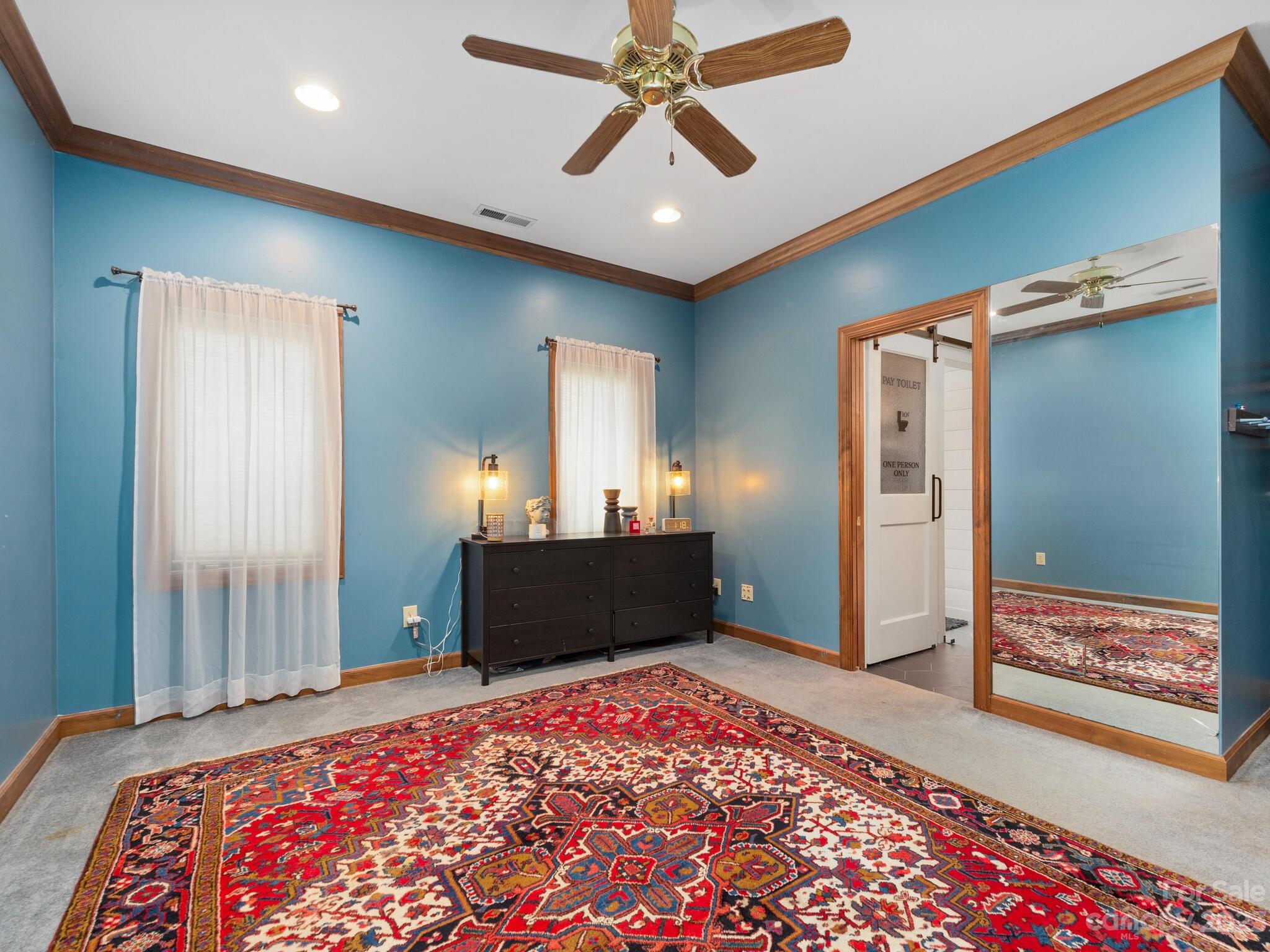 574 Golden Road Columbus, NC 28722 - Photo 37 of 48 a bedroom with a bed and a chandelier