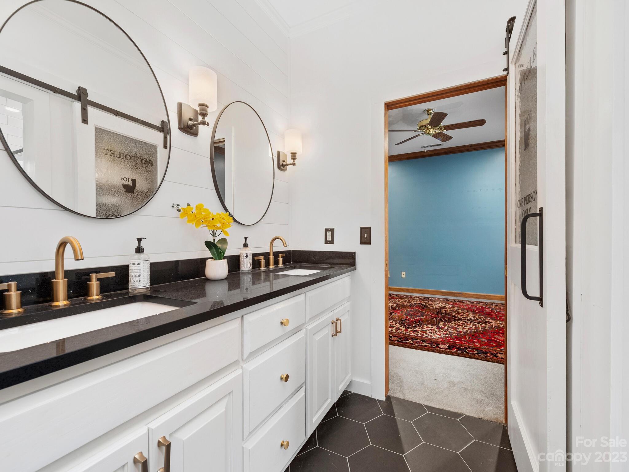574 Golden Road Columbus, NC 28722 - Photo 38 of 48 a bathroom with a double vanity sink and a mirror