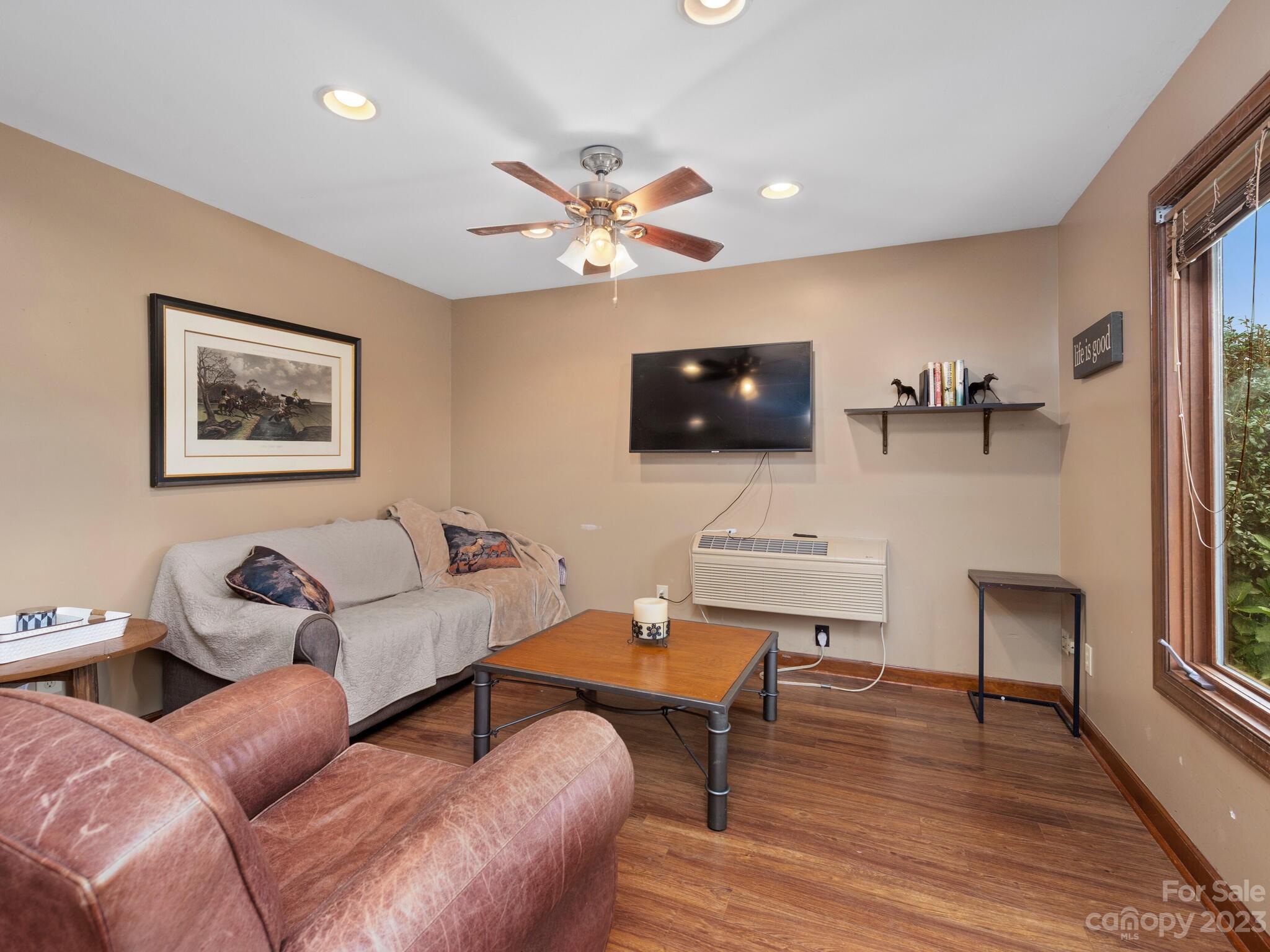 574 Golden Road Columbus, NC 28722 - Photo 42 of 48 a living room with furniture a flat screen tv and a window