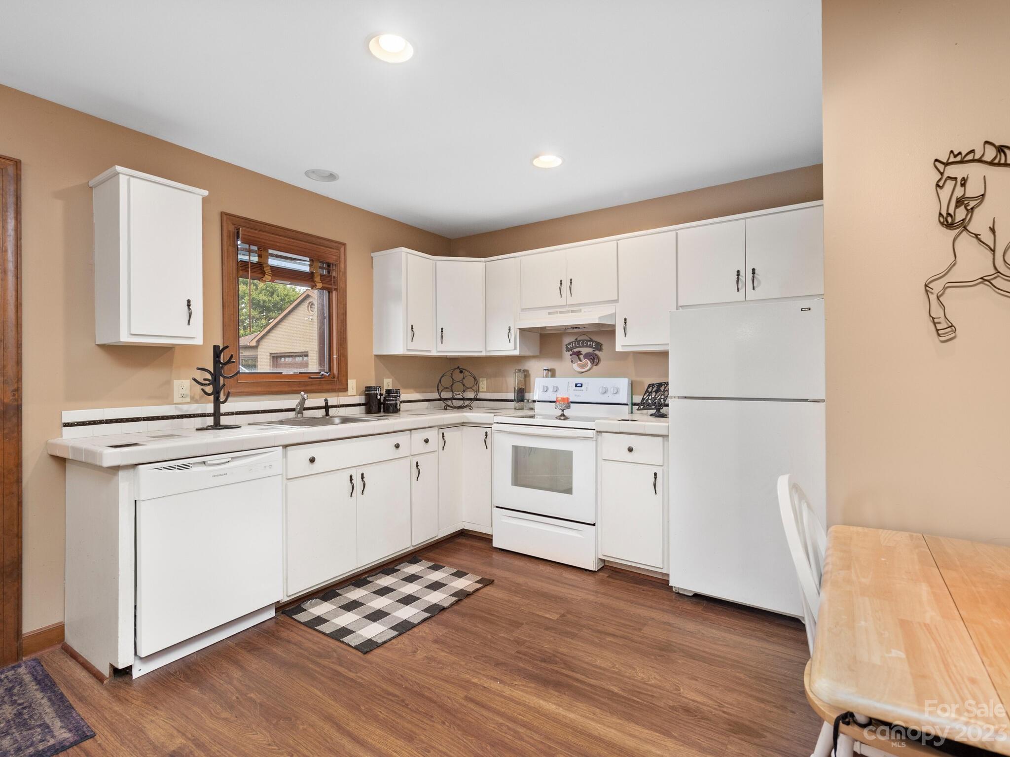 574 Golden Road Columbus, NC 28722 - Photo 43 of 48 a kitchen with white cabinets white appliances and sink