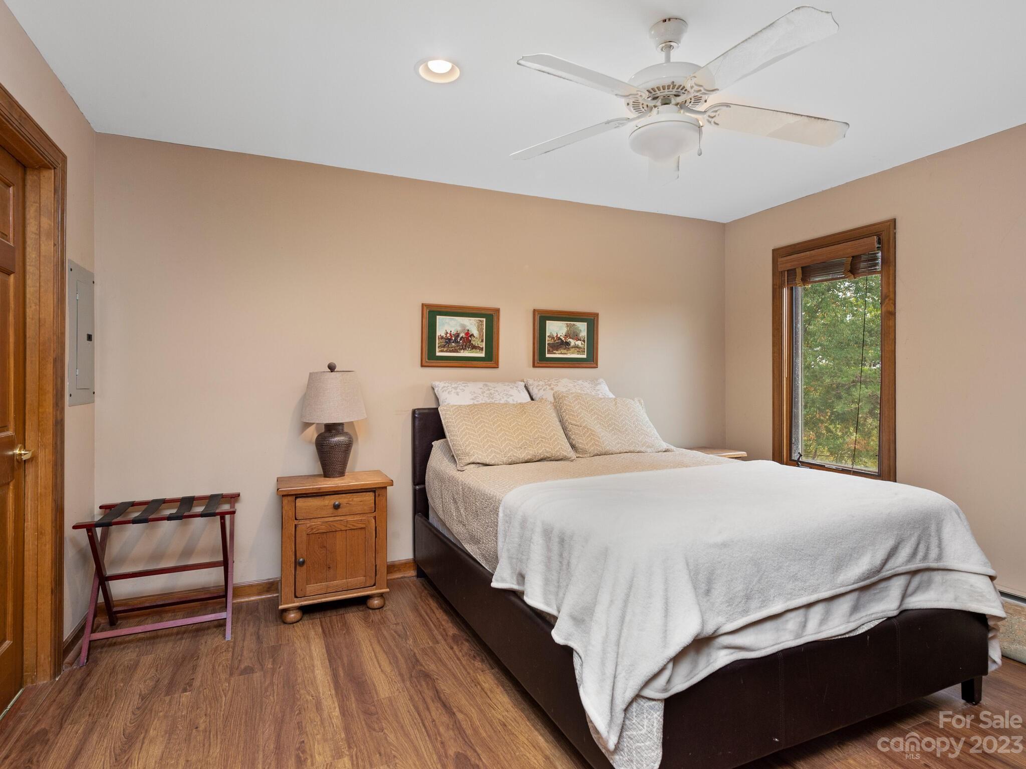 574 Golden Road Columbus, NC 28722 - Photo 45 of 48 a bedroom with a bed and a chandelier
