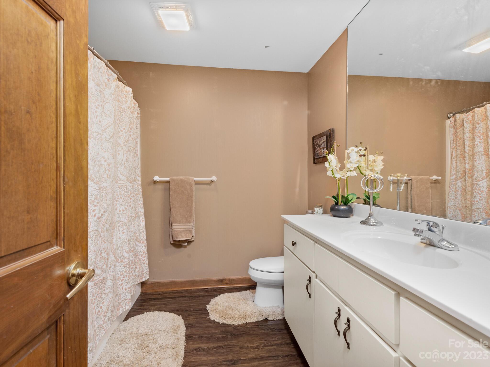 574 Golden Road Columbus, NC 28722 - Photo 46 of 48 a bathroom with a granite countertop sink toilet and shower