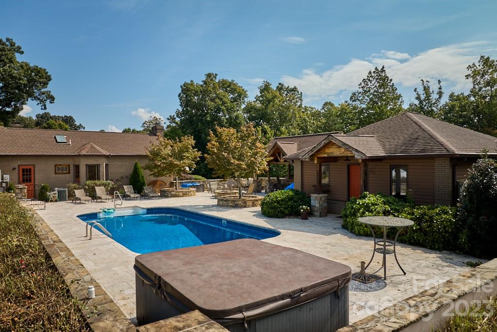 574 Golden Road Columbus, NC 28722 - Photo 8 of 48 a view of a house with swimming pool and sitting area