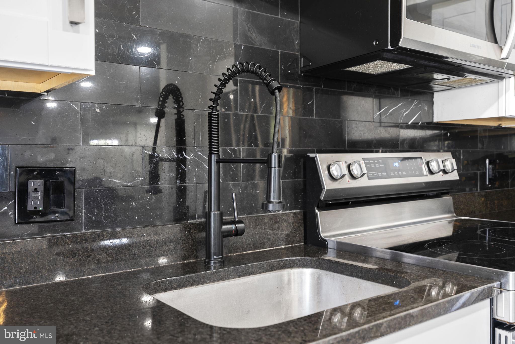 11317 Hawks Ridge Terrace, Unit 91 Germantown, MD 20876 - Photo 18 of 41 Sleek modern kitchen with elegant finishes.