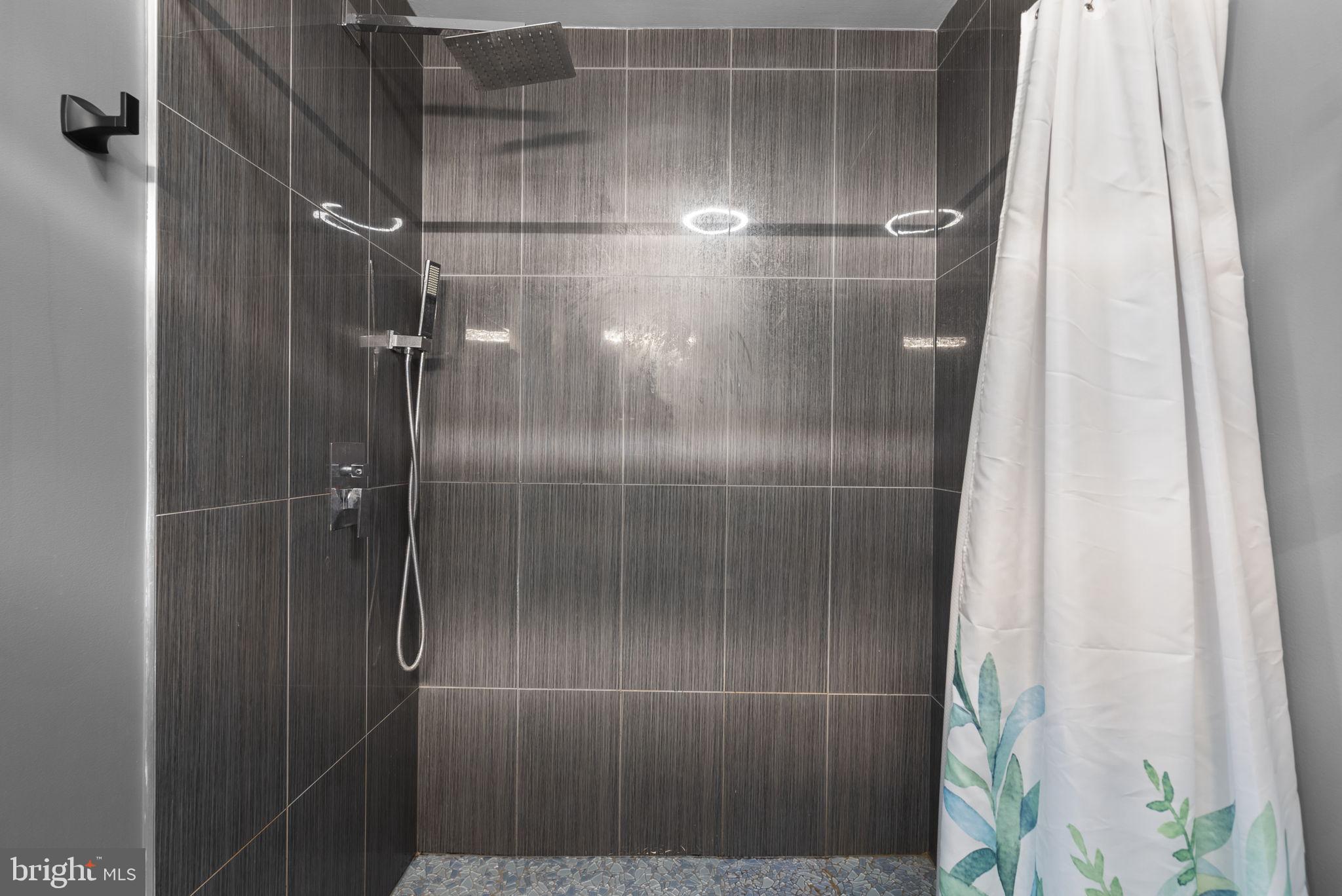 11317 Hawks Ridge Terrace, Unit 91 Germantown, MD 20876 - Photo 30 of 41 Sleek modern shower with elegant tiles.