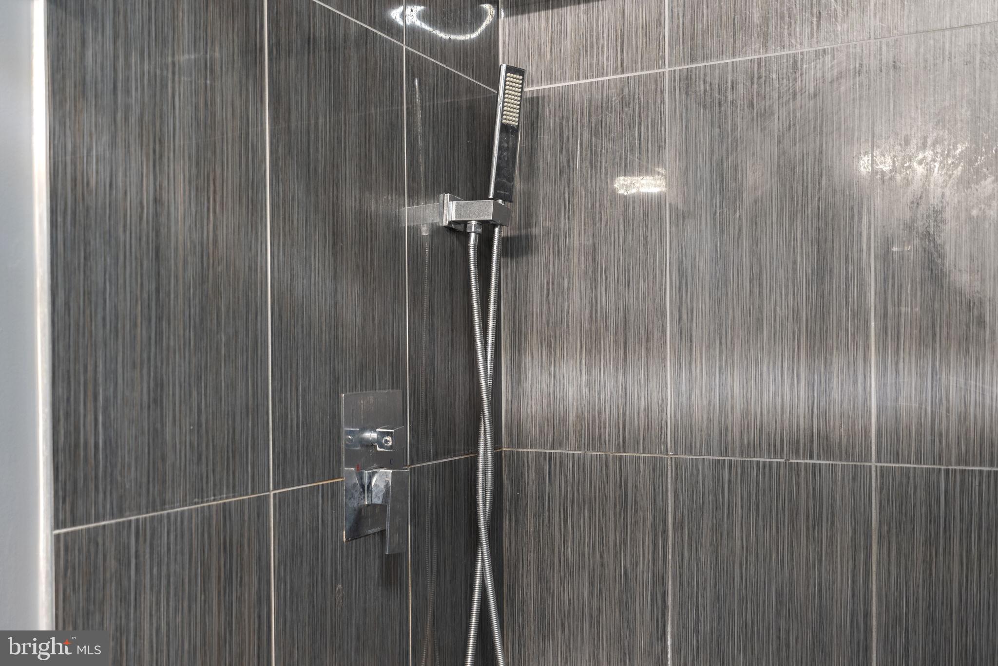 11317 Hawks Ridge Terrace, Unit 91 Germantown, MD 20876 - Photo 31 of 41 Sleek modern shower with elegant tiles.