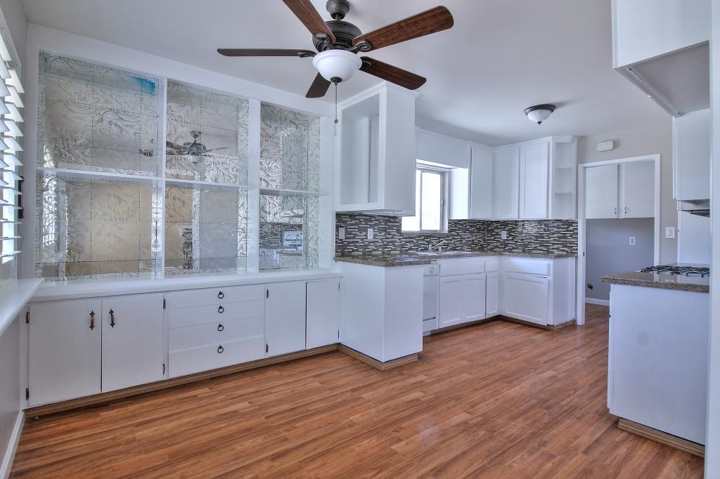 2760 Roop Road Gilroy, CA 95020 - Photo 5 of 16 a kitchen with granite countertop white cabinets and white stainless steel appliances