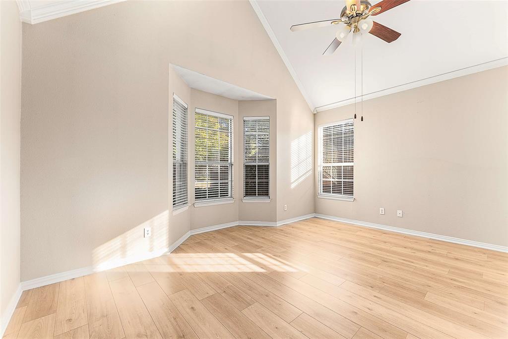 111 Midcrest Drive Irving, TX 75063 - Photo 11 of 26 a view of an empty room with a window and wooden floor