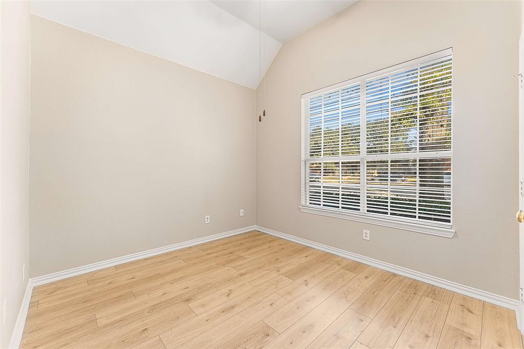 111 Midcrest Drive Irving, TX 75063 - Photo 16 of 26 a view of an empty room with wooden floor and a window