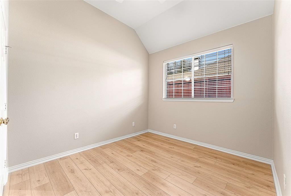 111 Midcrest Drive Irving, TX 75063 - Photo 18 of 26 a view of an empty room with wooden floor and a window