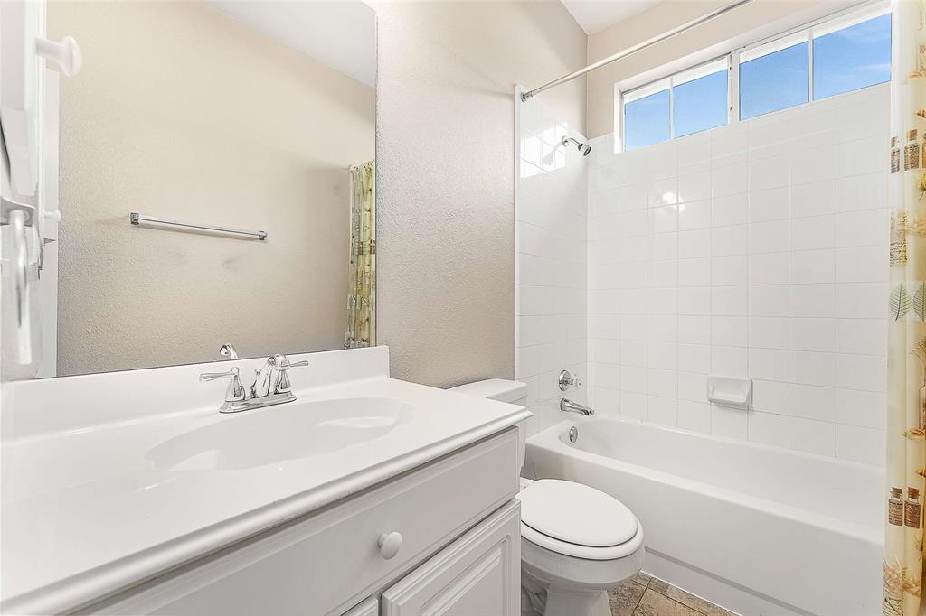 111 Midcrest Drive Irving, TX 75063 - Photo 20 of 26 a bathroom with a sink a toilet and a mirror