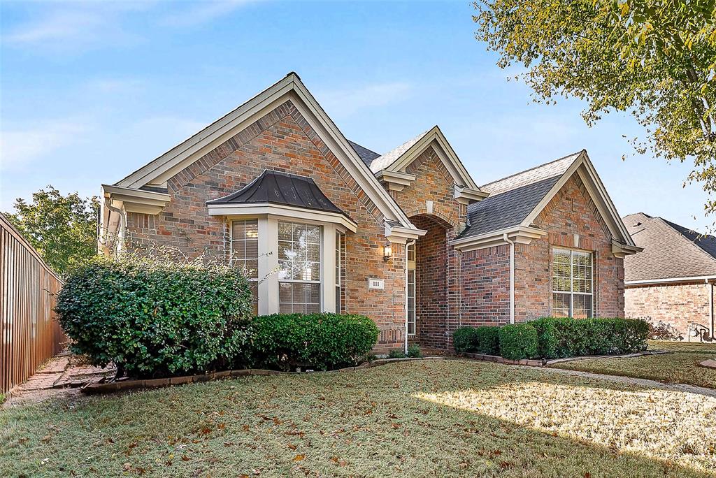 111 Midcrest Drive Irving, TX 75063 - Photo 2 of 26 a front view of a house with a yard