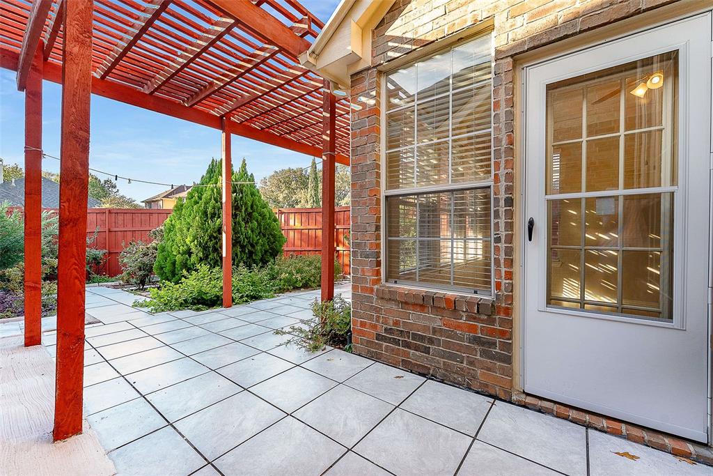 111 Midcrest Drive Irving, TX 75063 - Photo 22 of 26 a backyard of a house with potted plants