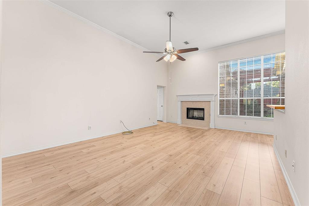 111 Midcrest Drive Irving, TX 75063 - Photo 4 of 26 a view of empty room with wooden floor and fireplace