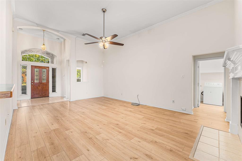 111 Midcrest Drive Irving, TX 75063 - Photo 5 of 26 a view of empty room with wooden floor and ceiling fan