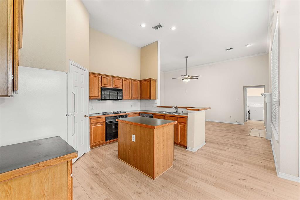 111 Midcrest Drive Irving, TX 75063 - Photo 7 of 26 a kitchen with stainless steel appliances granite countertop a sink a stove and a wooden floors