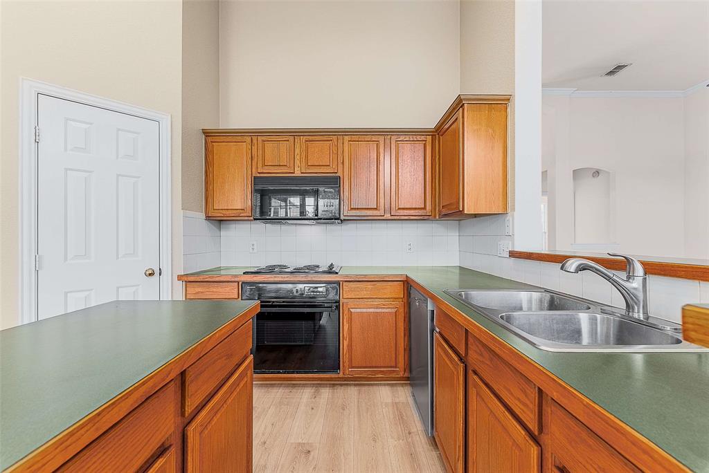 111 Midcrest Drive Irving, TX 75063 - Photo 8 of 26 a kitchen with stainless steel appliances granite countertop a sink stove and cabinets