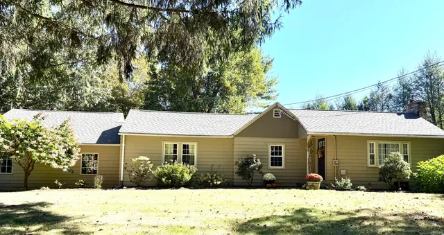 a front view of a house with a yard