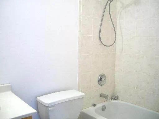 a bathroom with a shower a toilet and a shower