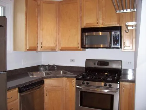 a kitchen with granite countertop a stove and a microwave