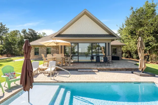 a front view of a house with a yard table and chairs
