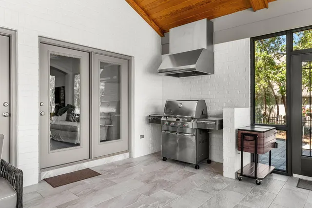 a bathroom with a granite countertop sink toilet and large mirror