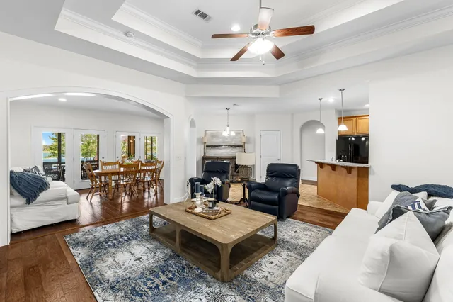 a front view of a house with a yard and trees