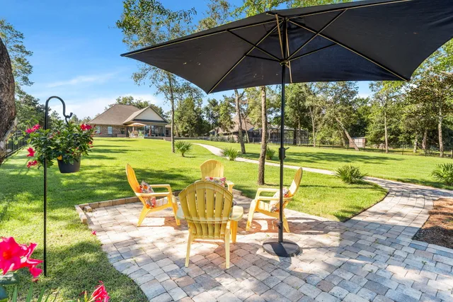 a view of a house with swimming pool and sitting area