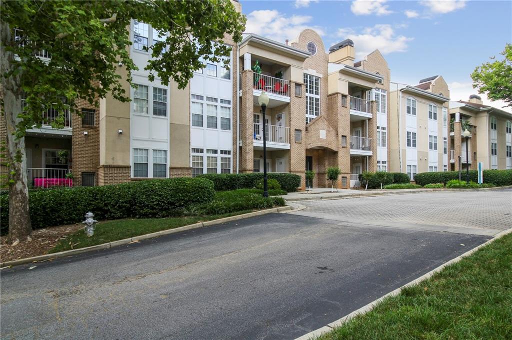 220 Renaissance Parkway Northeast, Unit 1303 Atlanta, GA 30308 - Photo 1 of 1 a front view of a building with garden
