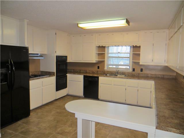 125 Hunter Road Fayetteville, TN 37334 - Photo 11 of 14 a kitchen with granite countertop white cabinets white stainless steel appliances a sink and a refrigerator