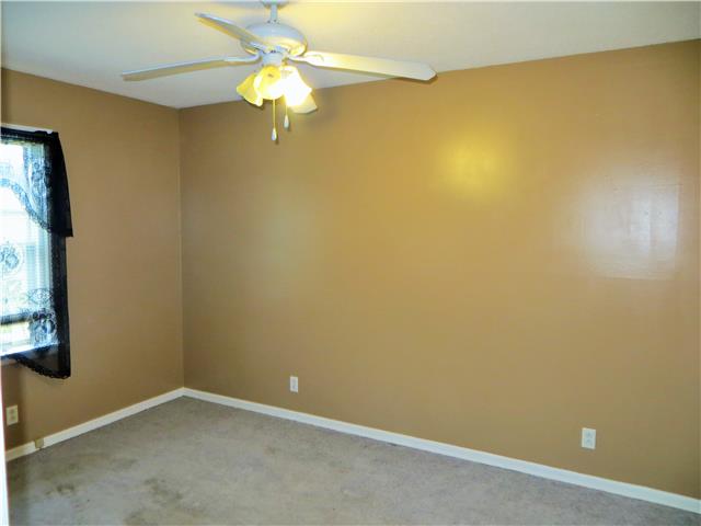 125 Hunter Road Fayetteville, TN 37334 - Photo 5 of 14 an empty room with a window and a ceiling fan