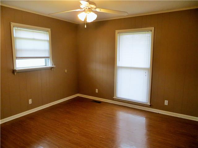 125 Hunter Road Fayetteville, TN 37334 - Photo 7 of 14 an empty room with wooden floor chandelier fan and windows