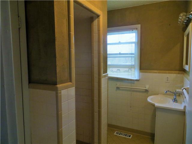 125 Hunter Road Fayetteville, TN 37334 - Photo 10 of 14 a bathroom with a sink a mirror and a window