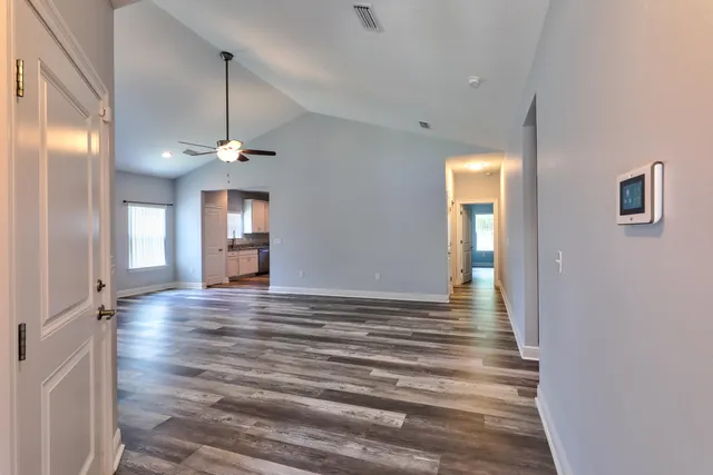 a view of wooden floor and windows in an empty room