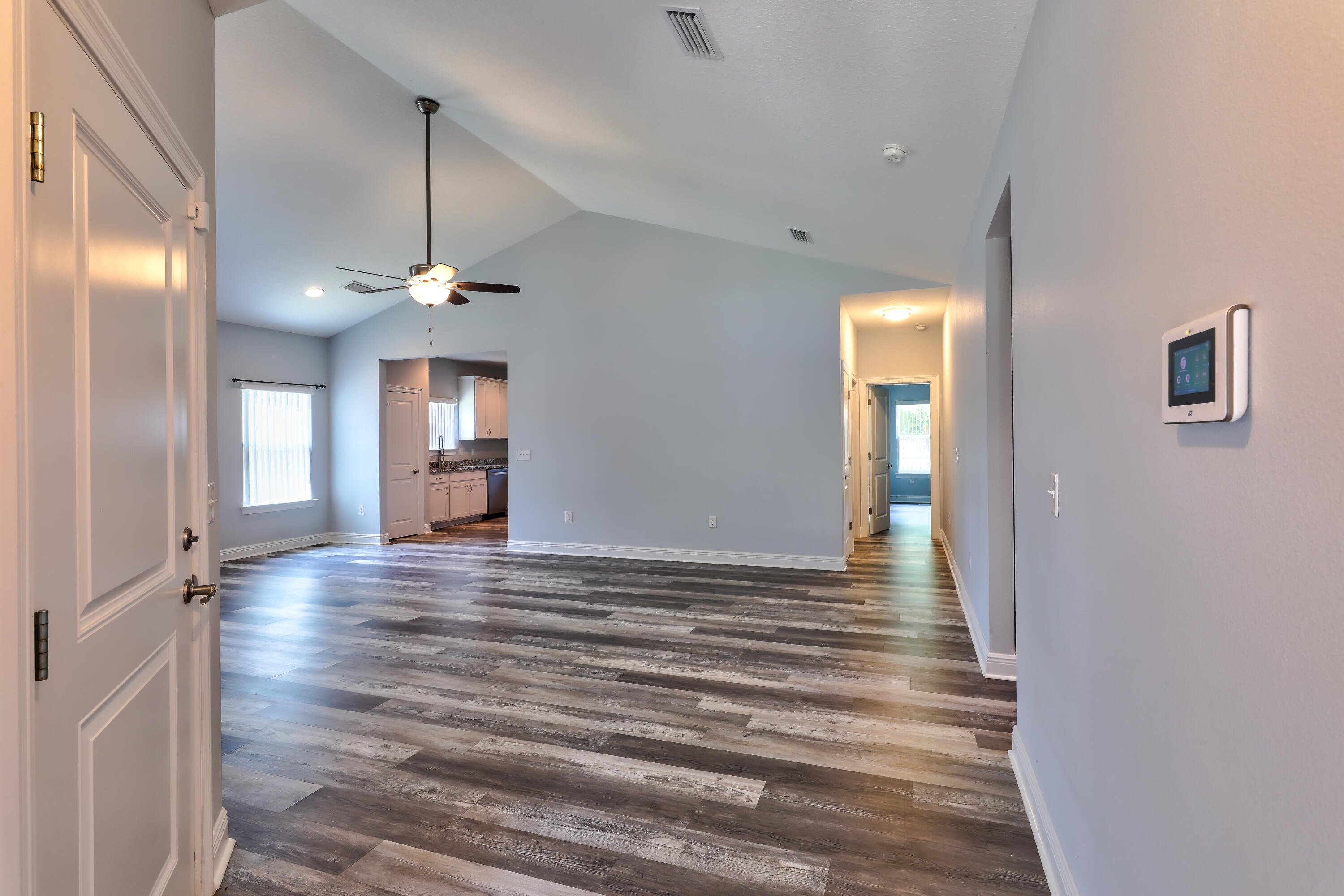 6160 Hayes Drive Crestview, FL 32539 - Photo 12 of 45 a view of an empty room with wooden floor and staircase
