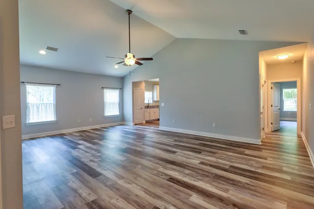 a view of a livingroom with a ceiling fan and window