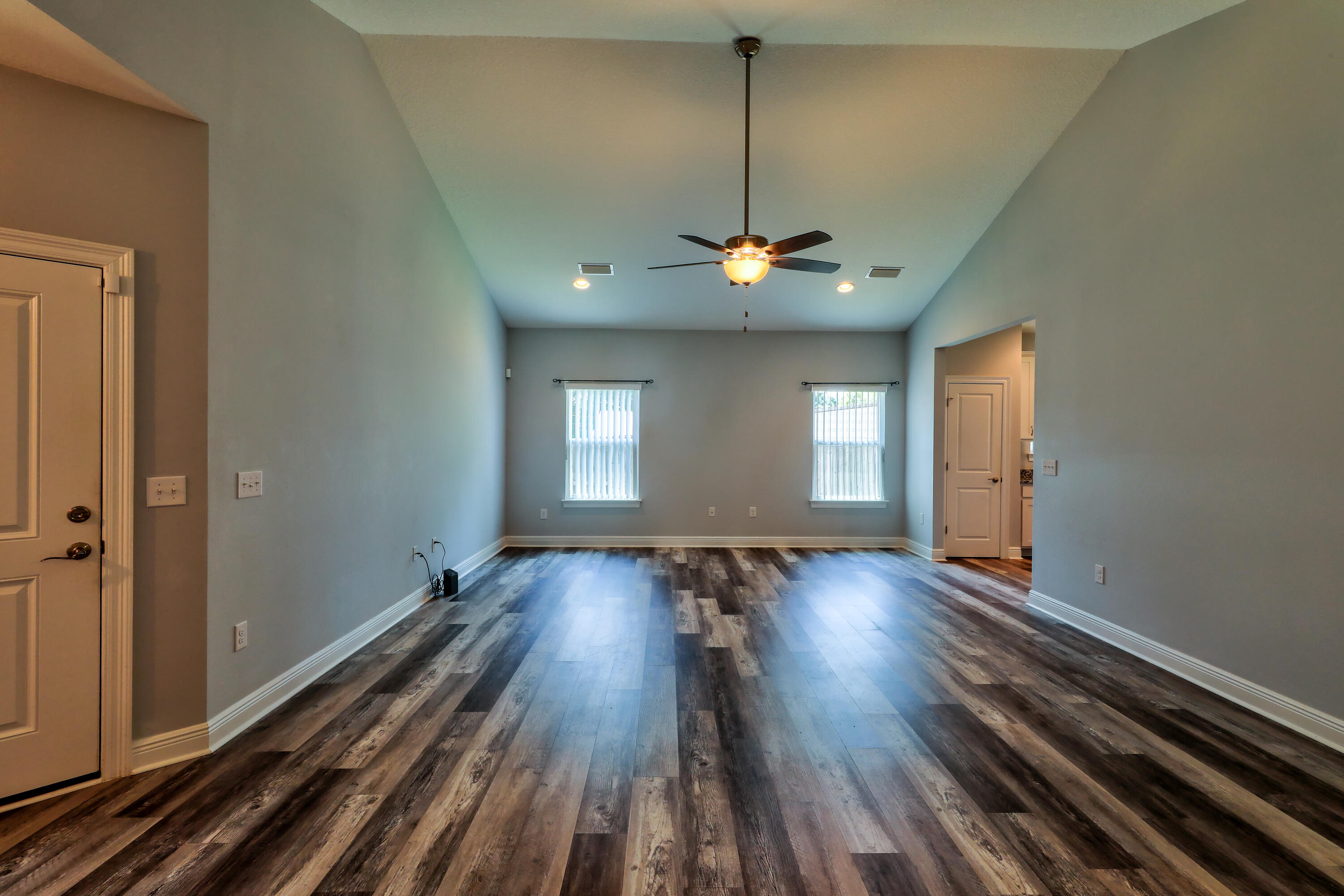 6160 Hayes Drive Crestview, FL 32539 - Photo 14 of 45 a view of wooden floor and windows in an empty room